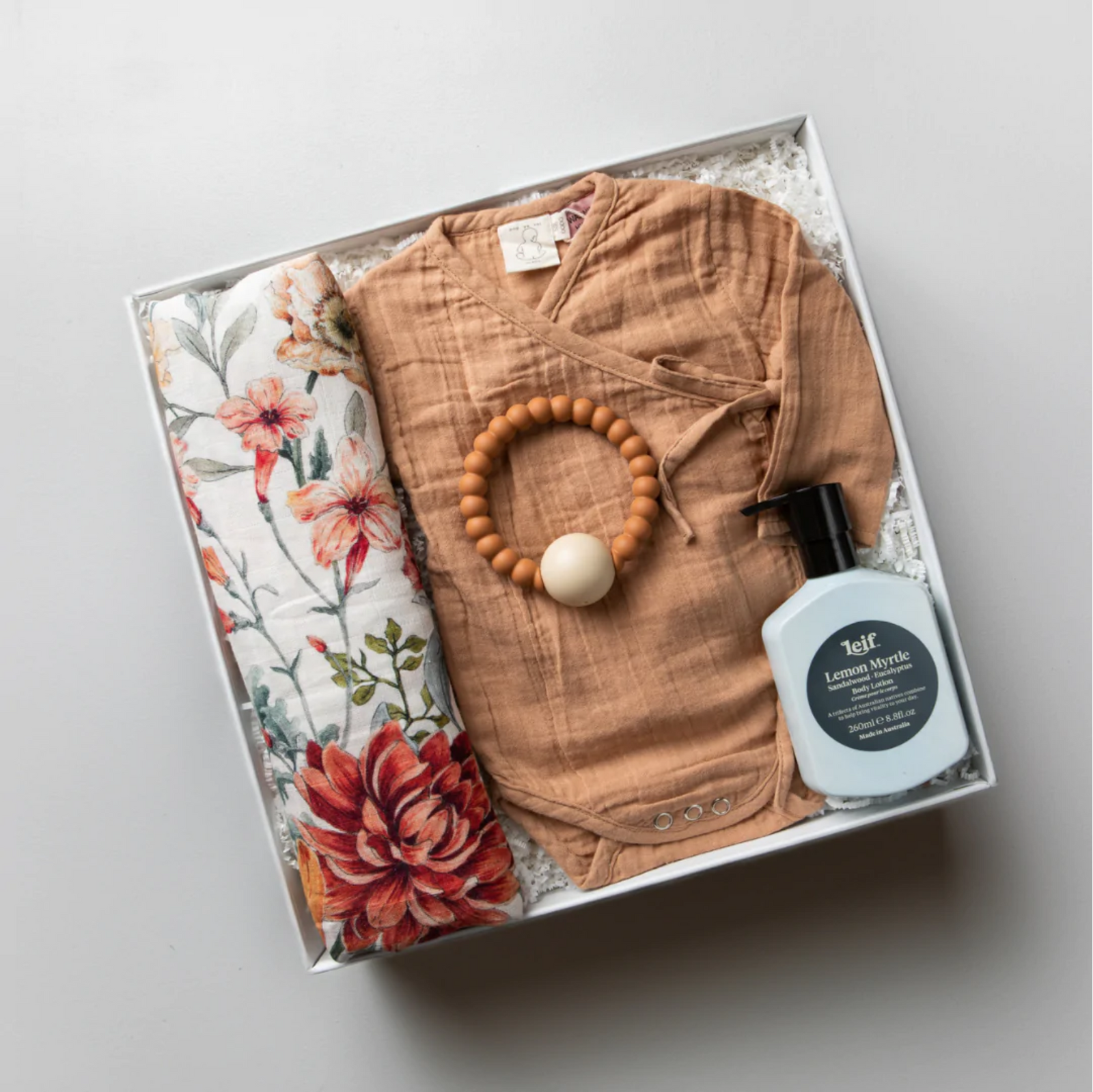 White gift box for baby shower or new baby or newborn. Muslin Wrap, Onesie, Teether, Body Lotion