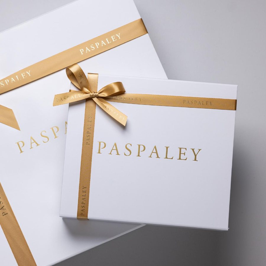 Custom branded Paspaley gift boxes with gold foil logo and printed ribbon, produced by LÂPACH.