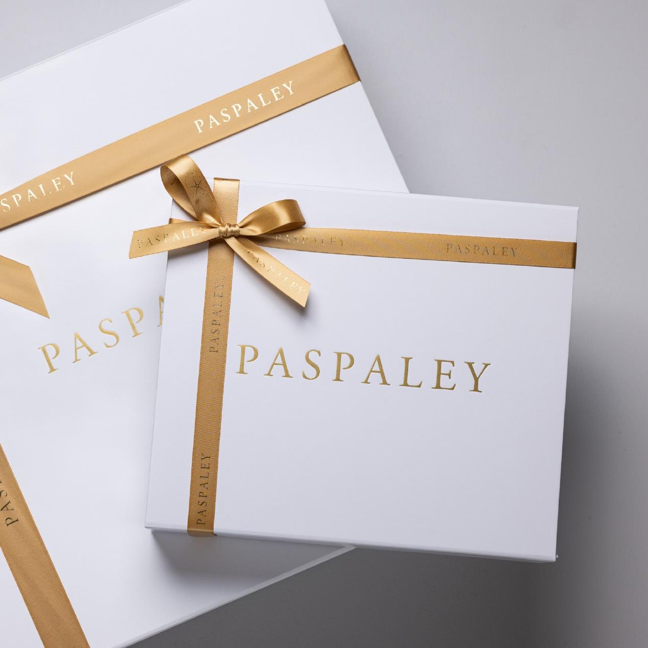 Custom branded Paspaley gift boxes with gold foil logo and printed ribbon, produced by LÂPACH.